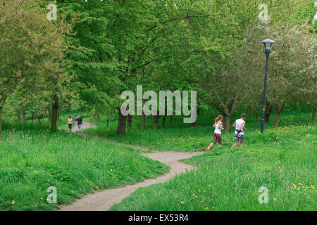 Park Prague, view of a young couple jogging in Petrin Park on a summer evening, Prague, Czech Republic. Stock Photo