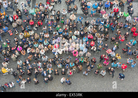 People looking up, overhead view of a crowd gathered in the Old Town Square in Prague to watch the famous Astronomical Clock strike the hour. Stock Photo