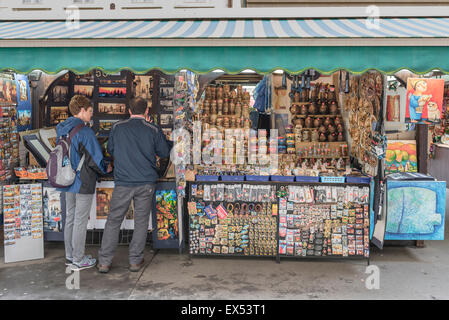 Prague havelska, rear view of tourists browsing a stall in Prague's largest market - the Havelske in the Stare Mesto district of the city. Stock Photo