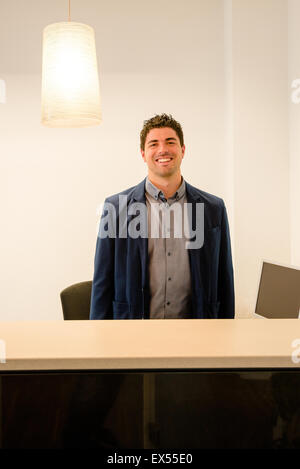 Young receptionist smiling Stock Photo