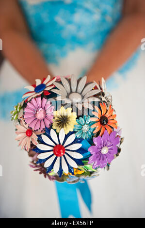 Bride holding her bridal bouquet made of metal colourful flowers Stock Photo