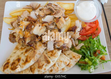 Chicken gyros portion with vegetables served on a plate offset Stock Photo