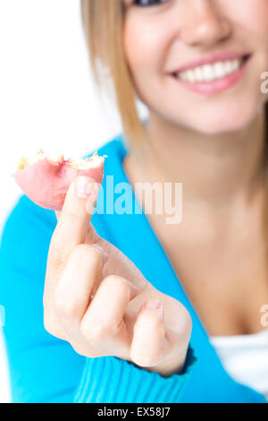 Portrait of young beautiful girl eating donut. Isolated on white. Stock Photo