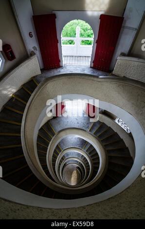 The spiral stairs in the Cloud Piercing Chinese Garden Pagoda is built up to reach the seventh storey with yellow lines along the edge of staircase. Stock Photo