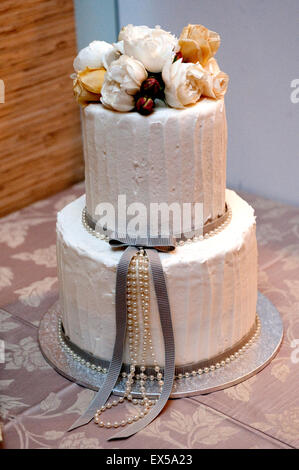 Decorated wedding cake with roses and pearls Stock Photo