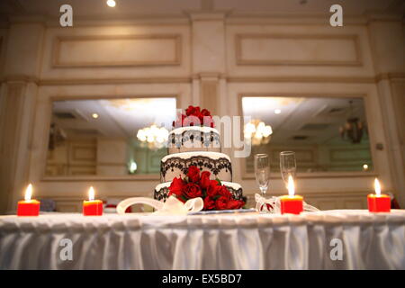 Decorated wedding cake with black lace and red roses Stock Photo