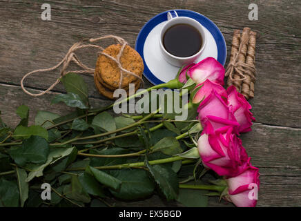 big bouquet of pink roses and cup of coffee, top view Stock Photo