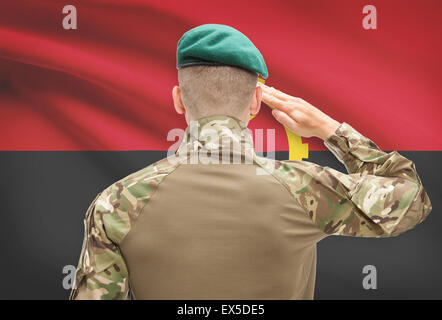 Soldier in hat facing national flag series - Angola Stock Photo