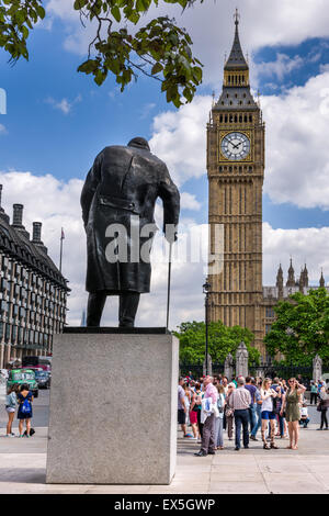 The statue of Sir Winston Churchill facing towards the  Elizabeth Tower which houses the world famous bell Big Ben. Stock Photo