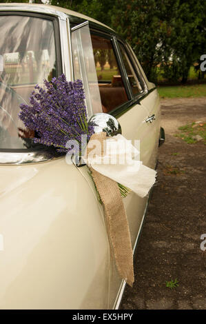 Bridal car decoration. Lavender and white ribbon on bridal vintage car mirror Stock Photo