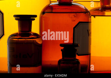 Closeup of vintage apothecary bottles assortment, back lighting Stock Photo