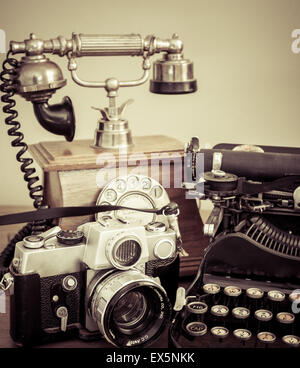 Retro vintage photo of an old type writer with phone and camea. Reminding of glorious past Stock Photo