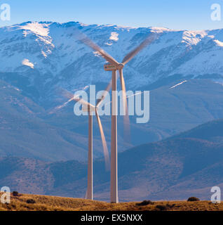 near Calahorra, Granada Province, Andalusia, southern Spain.  Two windmills with snowy mountains of the Sierra Nevada behind. Stock Photo