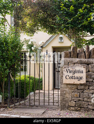 Wrought iron gate entrance to English country cottage Stock Photo