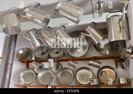 Coffee pots, pans, and jugs on display at tinsmiths shop in the Ulster American Folk Park Stock Photo