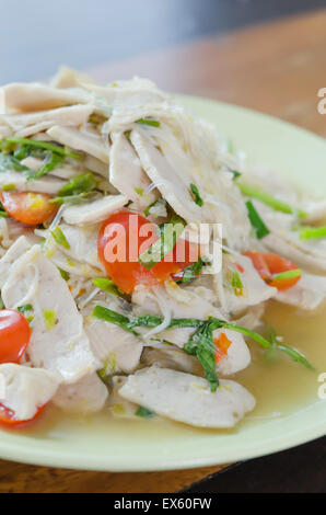 Spicy white pork sausage salad, Thai food on green dish Stock Photo