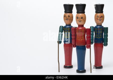 Three Wooden Antique Vintage Red  Blue Green Toy Soldiers White Background Stock Photo