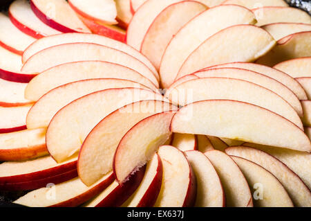 Apple slices arranged in skillet to make apple cake Stock Photo