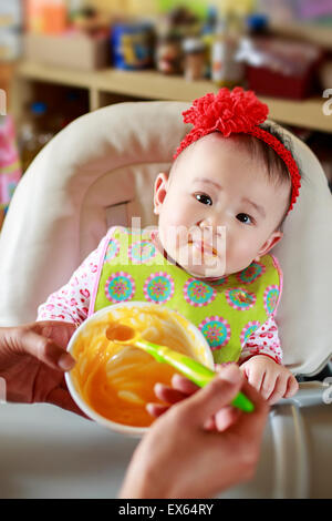 Baby Eating Solid Food Stock Photo