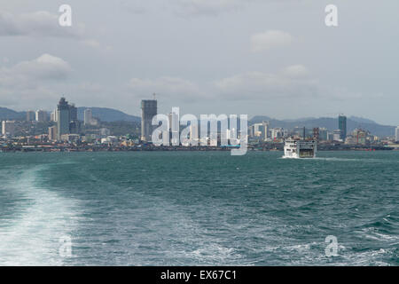 Skyline View of Cebu City from Lite Ferry with Wake Trailing in Water Behind Boat on Island of Cebu, Philippines Stock Photo