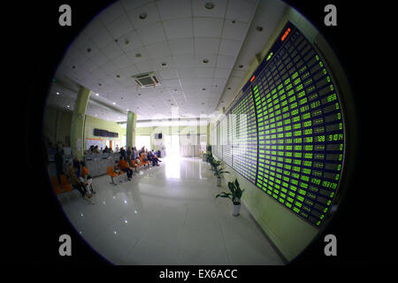 Nantong, China. 08th July, 2015. An investor watches the eclectic monitor at a stock exchange in Nantong, Jiangsu province, China on 8th July 2015. The CSI300 index of the largest listed companies in Shanghai and Shenzhen close down 6.8 percent, while the Shanghai Composite Index dropped 5.9 percent. Credit:  Panda Eye/Alamy Live News Stock Photo