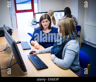 Young woman being trained on how to use software by manager Stock Photo