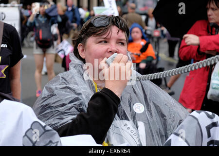 A disabled protester shouts slogans at a protest against welfare cuts. Stock Photo