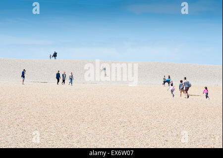 People making their way to and from Chesil Beach in Dorset, England UK. Near to the Chesil Beach Centre. Stock Photo