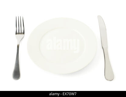 Fork and knife next to empty ceramic plate Stock Photo