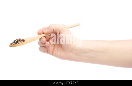 Hand holding a spoon full of pepper spices Stock Photo