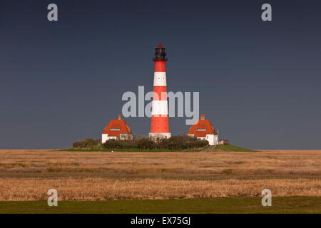 Dark rain cloud rolling in over lighthouse Westerheversand at Westerhever, Wadden Sea National Park, North Frisia, Germany Stock Photo