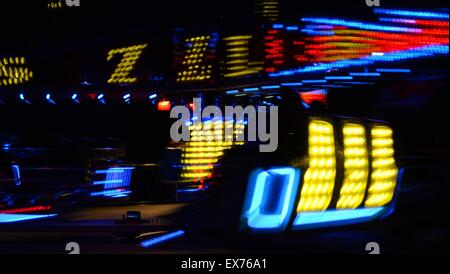 Blurred lights on a spinning fairground ride Stock Photo