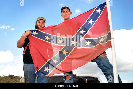 Sonoita, Arizona, USA, 7th July, 2015:  Caleb Gates, 20, (left), and Ray Helton, 22, display the Confederate flag attached to the truck that Gates was driving in Sonoita, Arizona, USA.  About the flag Gates says, 'It is part of Southern heritage.  I think it means rebellion, not racism.  Some of my best friends are Black and Mexican'.  Helton says, 'I don't see it as racist'.  Controversy over the Confederate battle flag has escalated across the southern states after the killings at Emanuel African Methodist Episcopal Church in South Carolina. Credit:  Norma Jean Gargasz/Alamy Live News Stock Photo