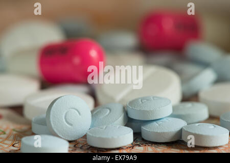 Mixture pills aspirin Ibuprofen painkiller over the counter without a prescription blue amitriptyline tricyclic antidepressant Stock Photo