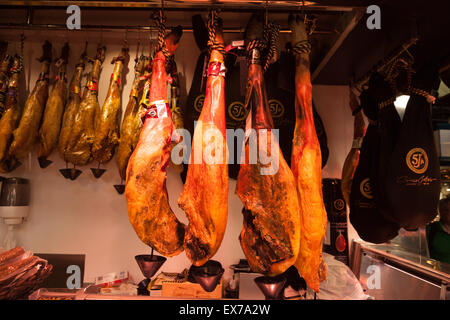 La Boqueria Barcelona - Serrano hams hanging in a meat stall, La Boqueria market, Las Ramblas, Barcelona Spain Europe Stock Photo