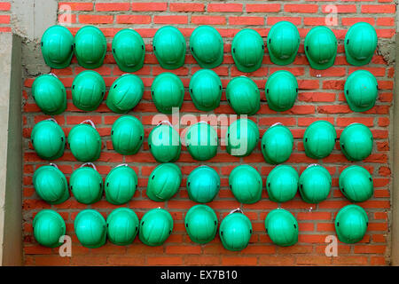 Many green construction helmets waiting to be used Stock Photo