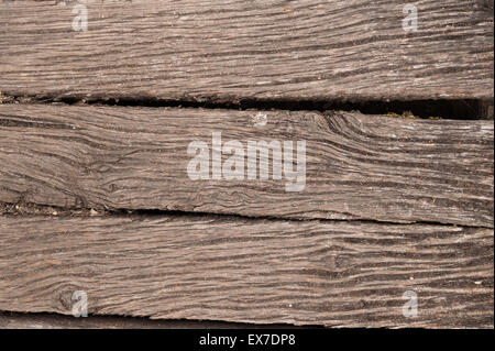 Gnarled weathered old English oak timber four by two inch beams used for deteriorating bridge footpath showing worn grain Stock Photo