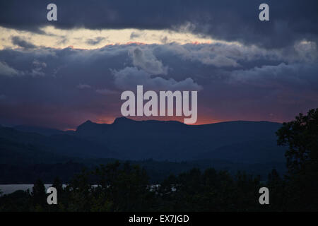 Windermere, Cumbria, UK. 08th July, 2015. The changeable British summer weather with a Dramatic Sunset photographed from the vantage point above Millerground Landing on Lake Windermere looking across the Lake to Iron Keld, Black Fell and Park Fell. Credit:  David Billinge/Alamy Live News Stock Photo