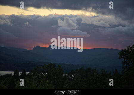 Windermere, Cumbria, UK. 08th July, 2015. The changeable British summer weather with a Dramatic Sunset photographed from the vantage point above Millerground Landing on Lake Windermere looking across the Lake to Iron Keld, Black Fell and Park Fell. Credit:  David Billinge/Alamy Live News Stock Photo