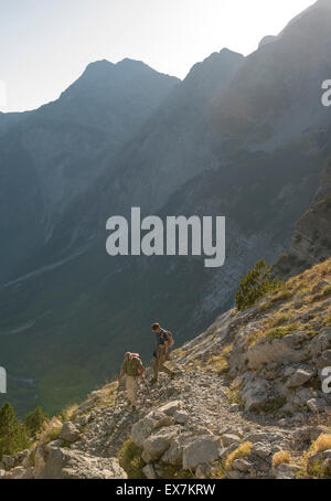 Hiking from Gusinje, Montenegro to Theth, Albania.  This photo taken in Albania headed down to the valley of Theth below. Stock Photo