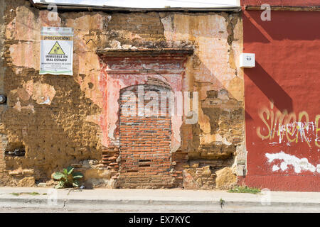 Interesting textures of a crumbling brick and plaster wall in Oaxaca Mexico Stock Photo