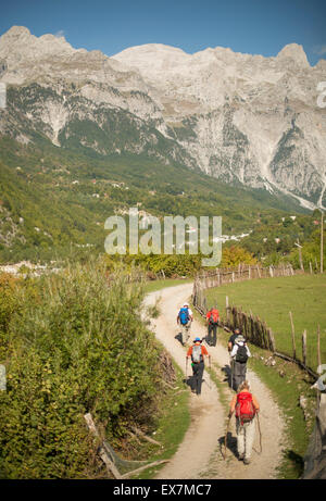 Theth, Albania. Hikers walking through valley. Stock Photo