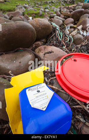 Plastic rubbish washed ashore on Rubha Coigeach in Assynt, Scotland, UK, including a bilge clean bottle from shipping. Stock Photo