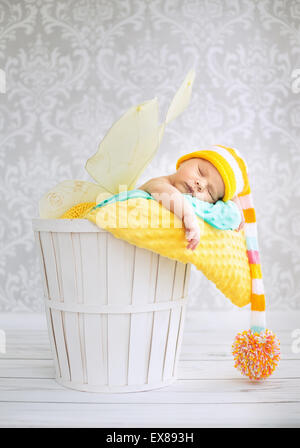 Little kid sleeping in the wicker basket