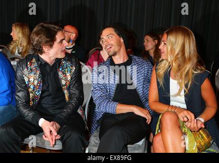 Berlin, Germany. 08th July, 2015. 'Breaking Bad' actor RJ Mitte, Tom Payne and Jennifer Akerman (l-r) at the Kilian Kerner Fashion Show at Mercedes-Benz Fashion Week Spring/Summer 2016. Credit:  dpa picture alliance/Alamy Live News Stock Photo