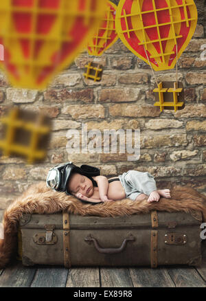 Cute child sleeping on the luggage Stock Photo