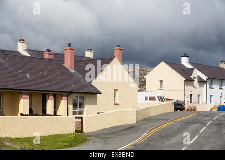 Housing in Tarbert on the Isle of Harris, Outer Hebrides, Scotland, UK, with rugged scenery behind. Stock Photo