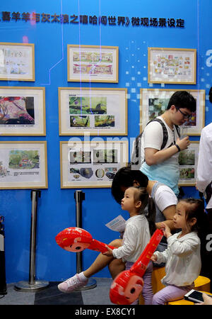 Shanghai, China. 9th July, 2015. Children watch cartoons during the 11th China International Cartoon & Game Expo in Shanghai, east China, July 9, 2015. The five-day fair kicked off here on Thursday, attracting more than 300 exhibitors at home and abroad. Credit:  Liu Ying/Xinhua/Alamy Live News Stock Photo