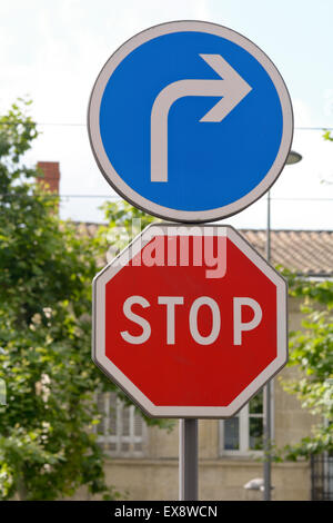 Stop and turn right road signs at road junction Stock Photo