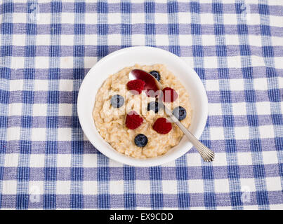 Bowl of hot, fresh oatmeal with raspberries and blueberries Stock Photo